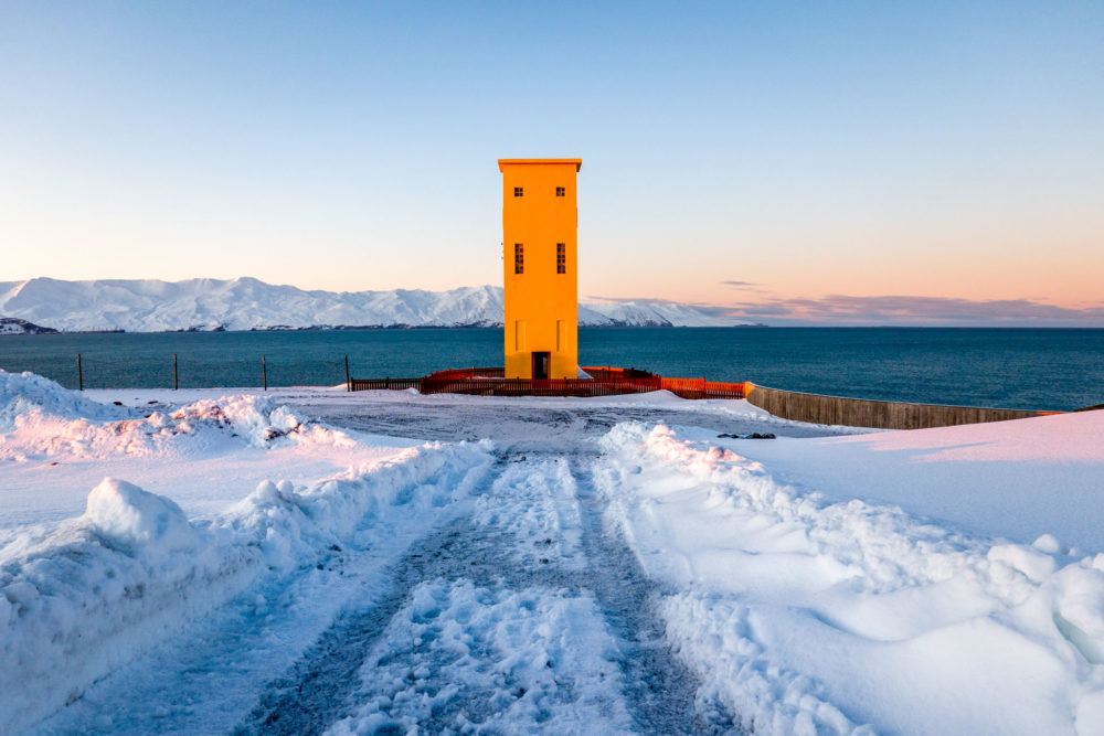 The big yellow Husavik lighthouse sits at the lower entrance to GeoSea.