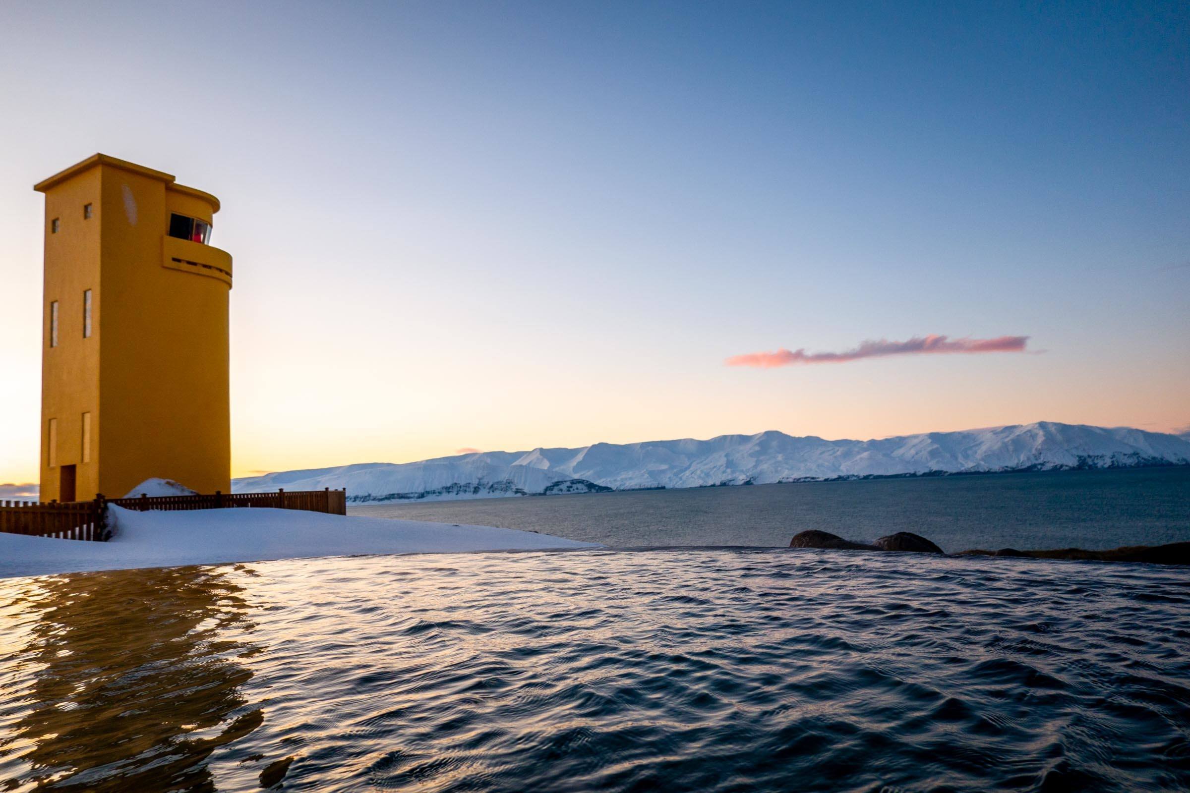 The iconic yellow lighthouse of Husavik adjacent to the Iceland thermal baths of GeoSea.