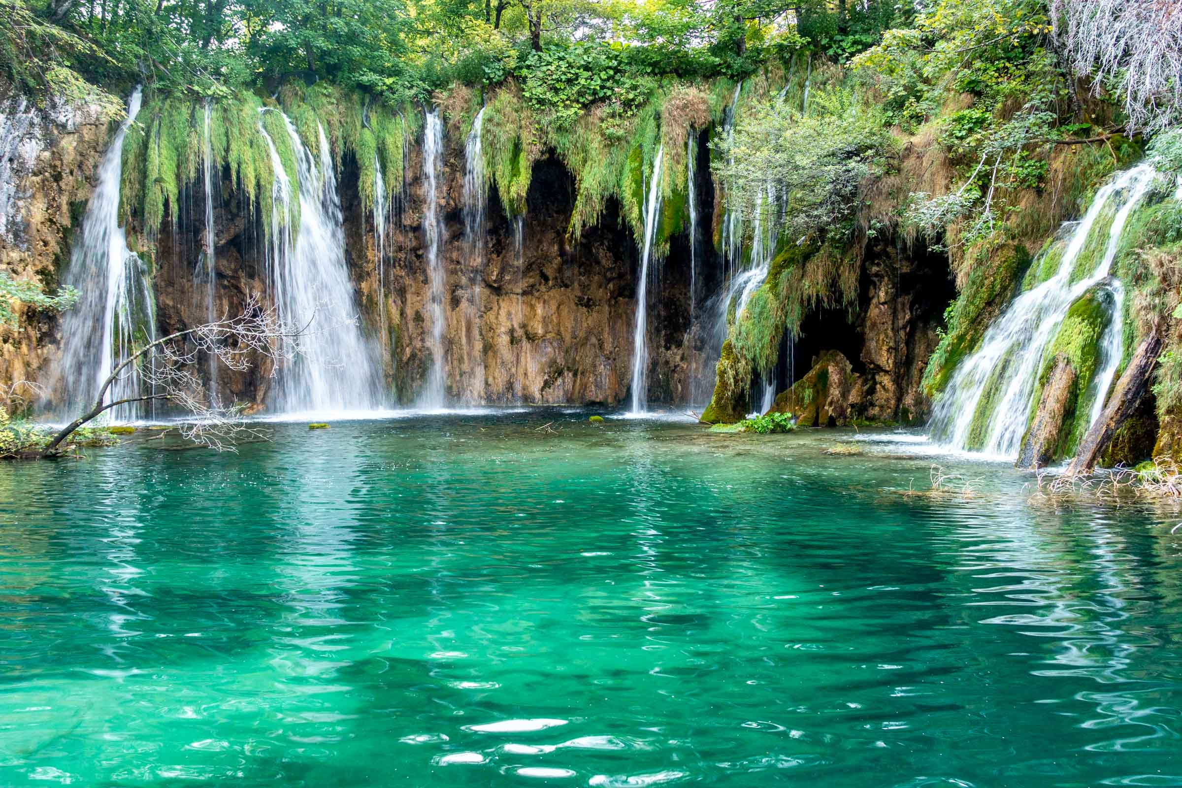 Waterfalls falling into lake at Pltvice Lakes National Park in Croatia
