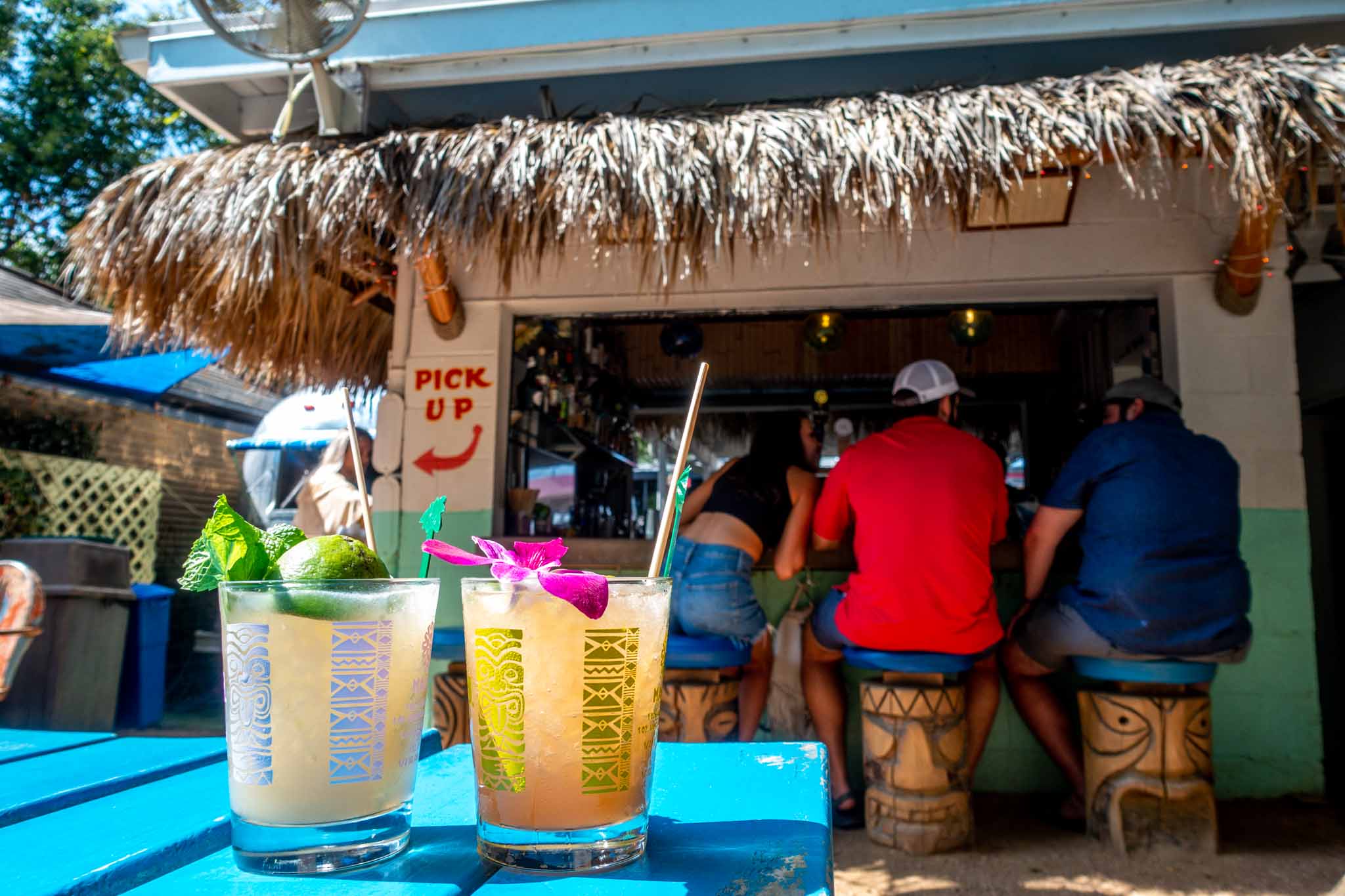 Two cocktails in tiki glasses