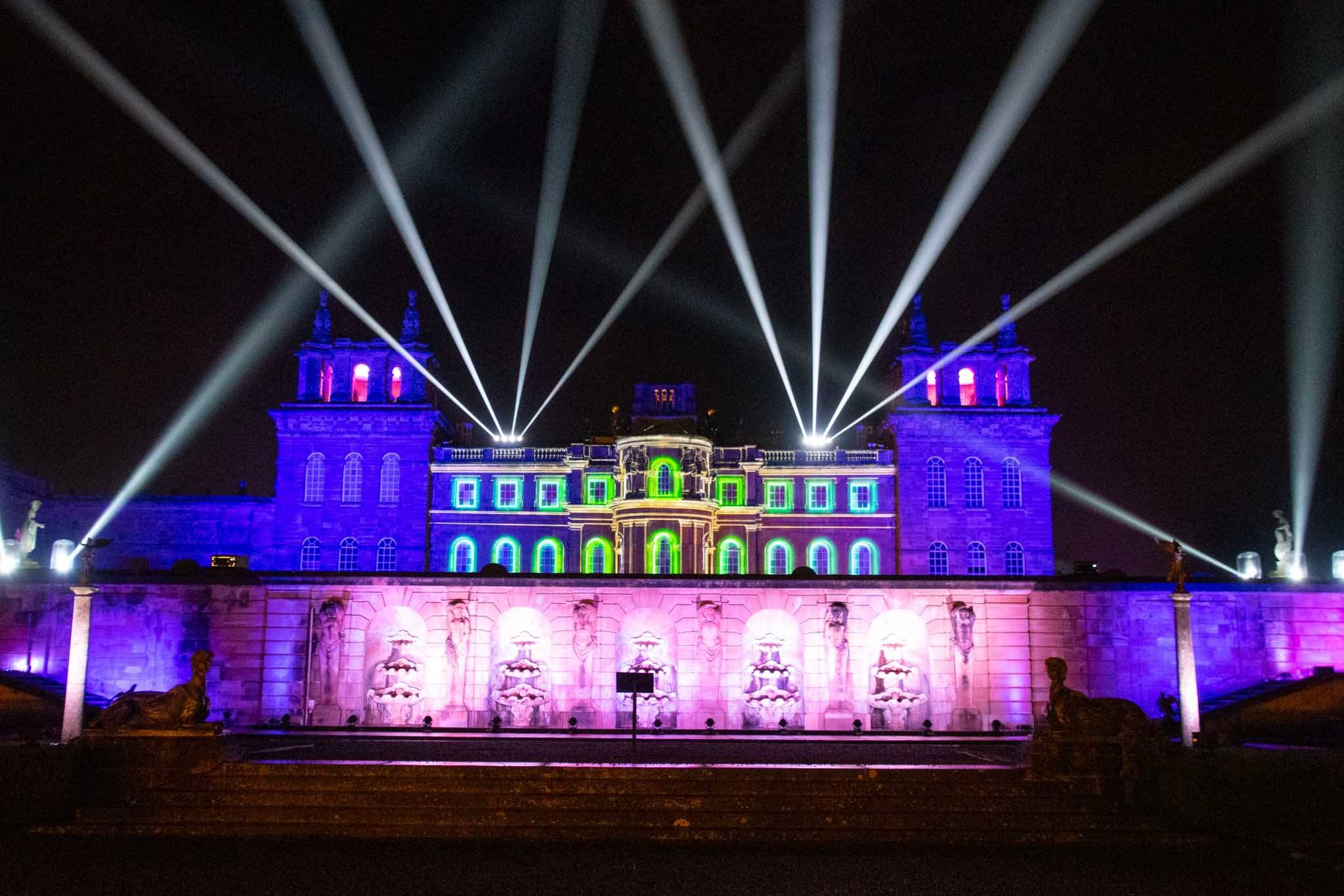 Exterior of a large building lit with colorful lights for Christmas