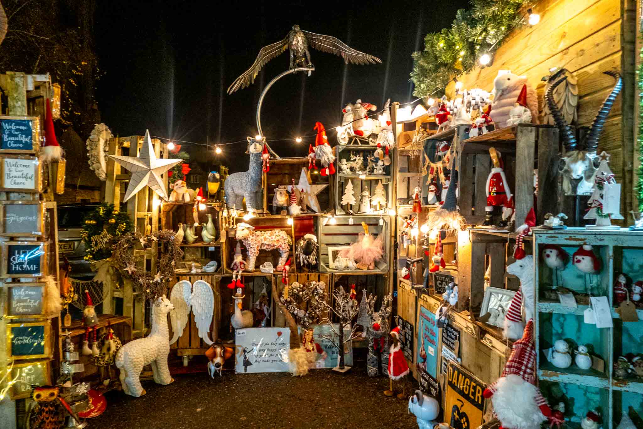 Dolls and stuffed animals on wooden shelves for sale