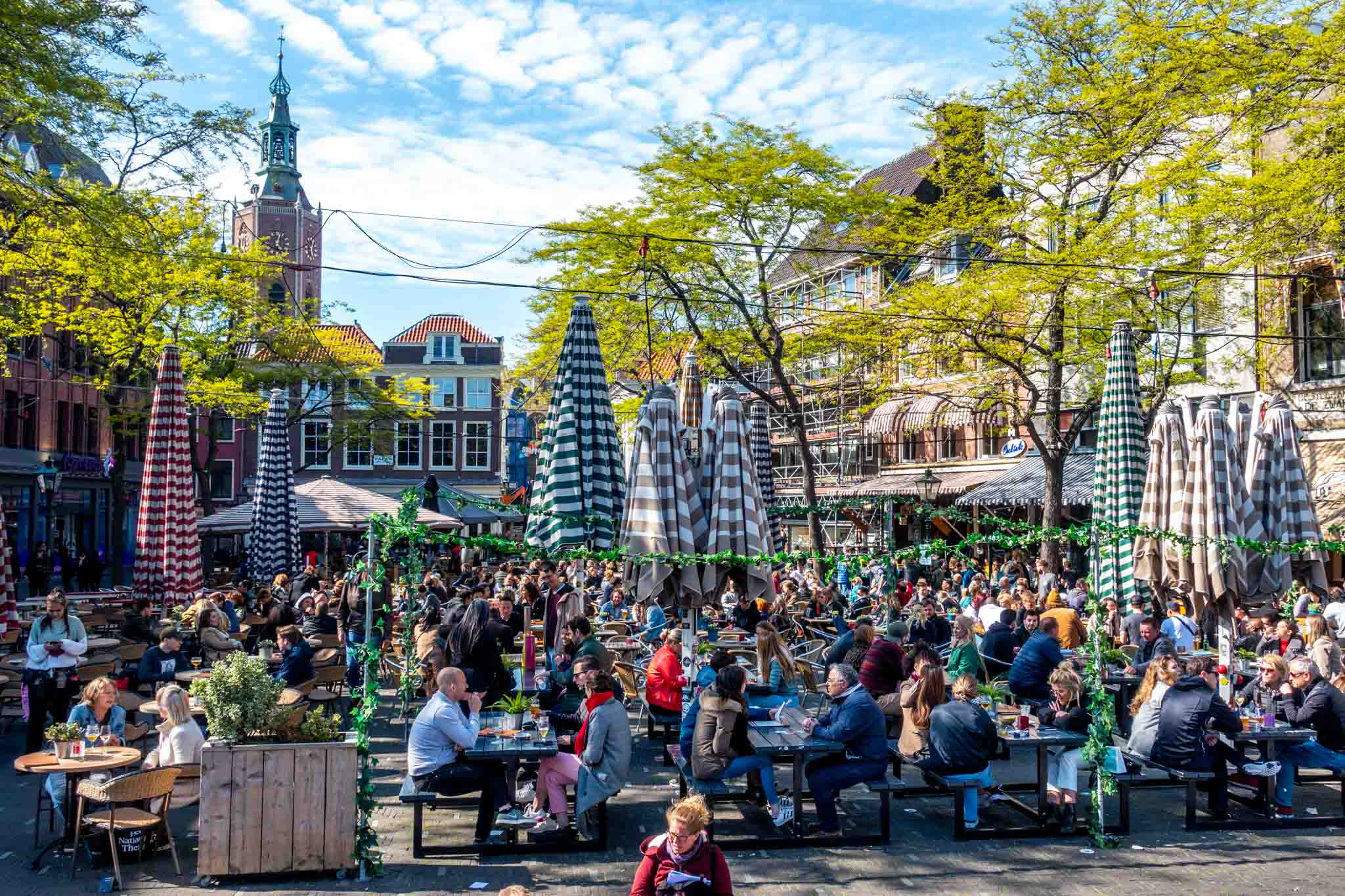 People at picnic tables in Grote Markt square