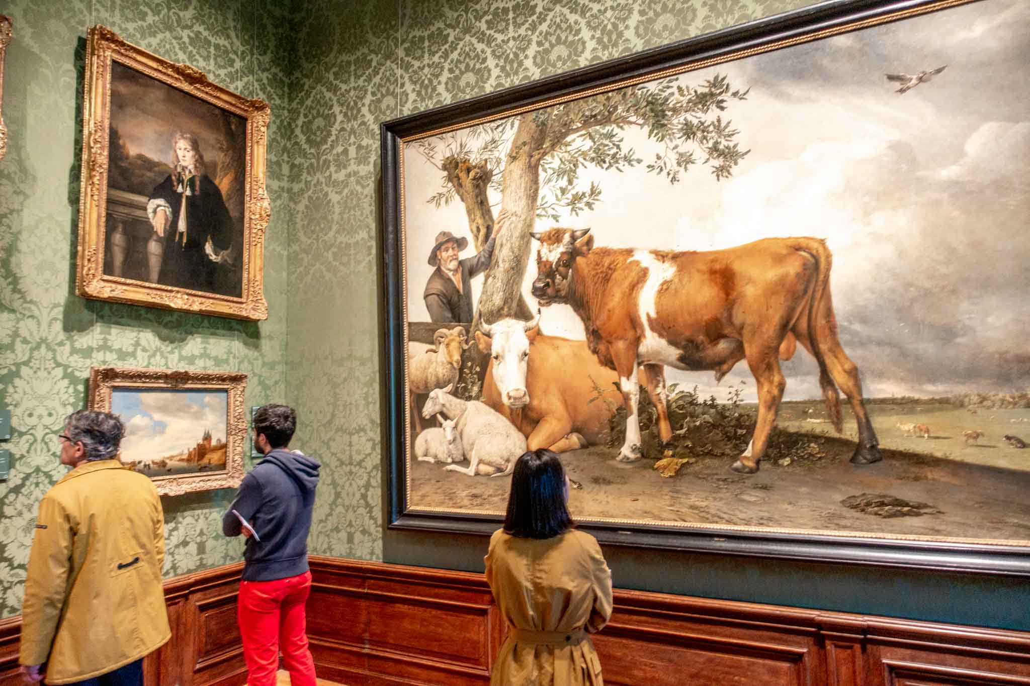 Visitors looking at paintings in the Mauritshuis gallery