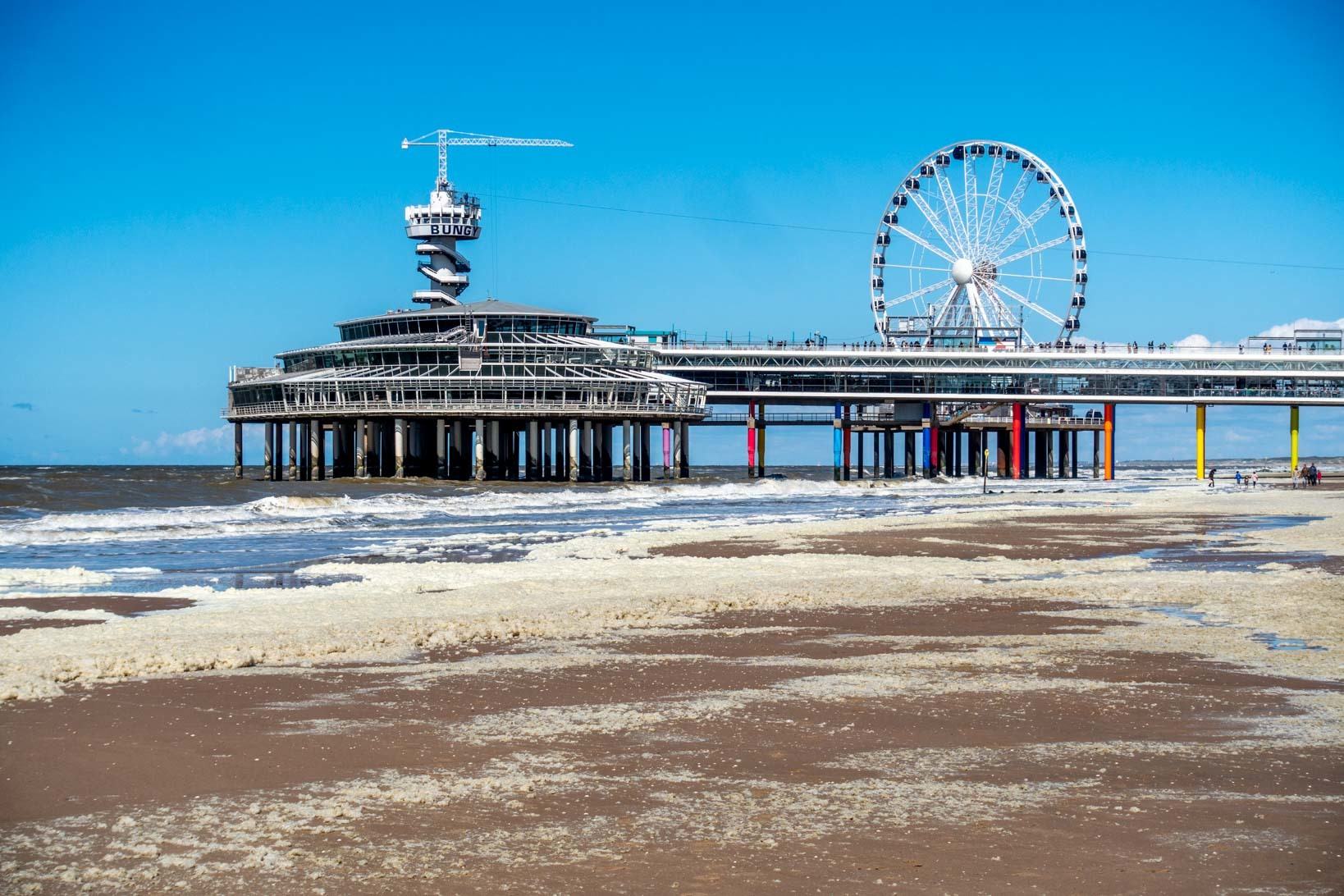 Large pier and Ferris wheel stretching from the beach out to the ocean
