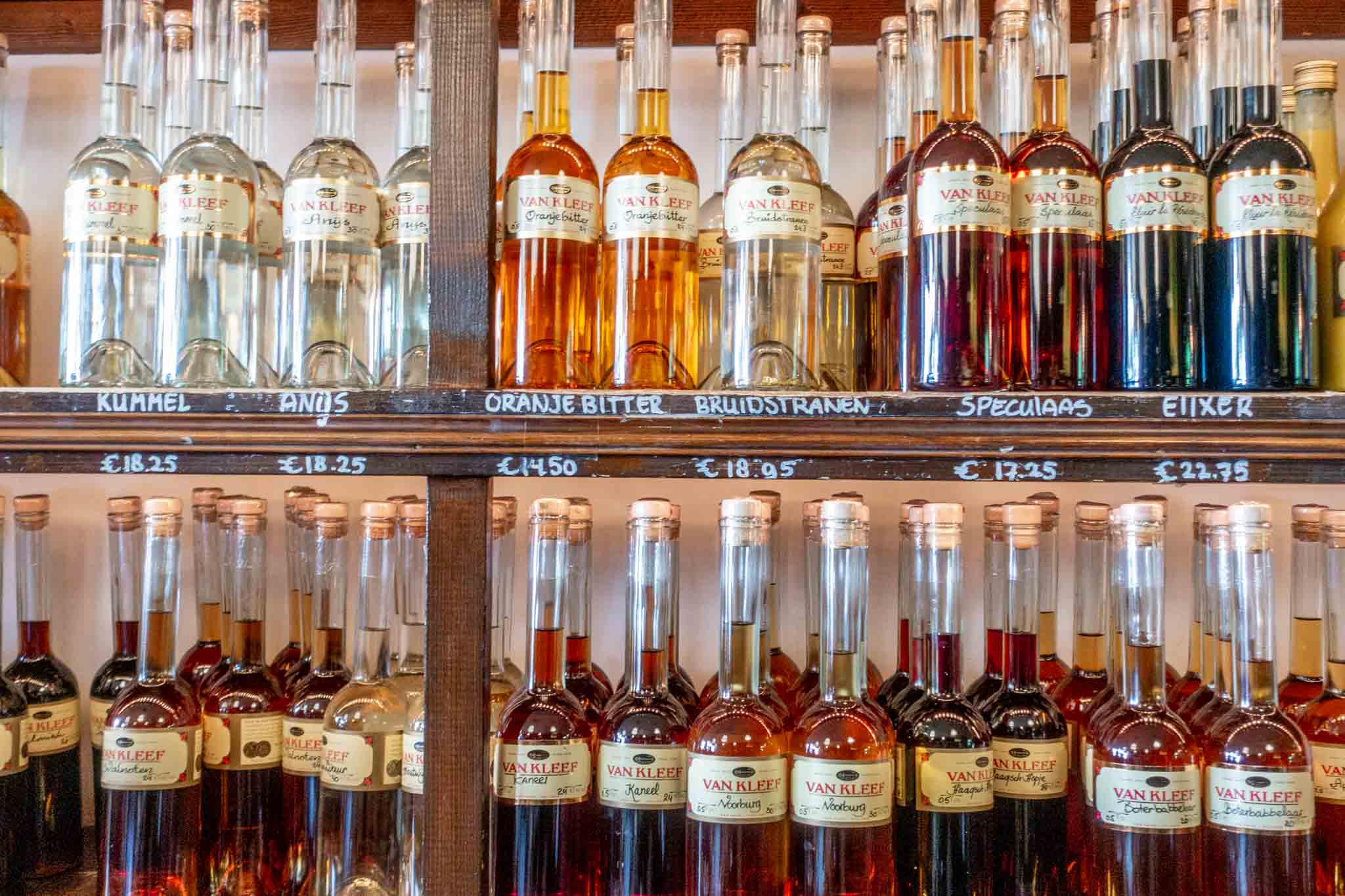 Bottles of liqueurs and genevers lined up on shelves